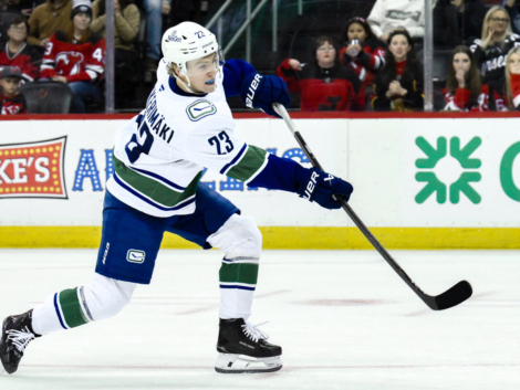 Mar 24, 2025; Newark, New Jersey, USA; Vancouver Canucks right wing Jonathan Lekkerimaki (23) shoots and scores a goal during tovertime shootouts against the New Jersey Devils at Prudential Center. Mandatory Credit: John Jones-Imagn Images