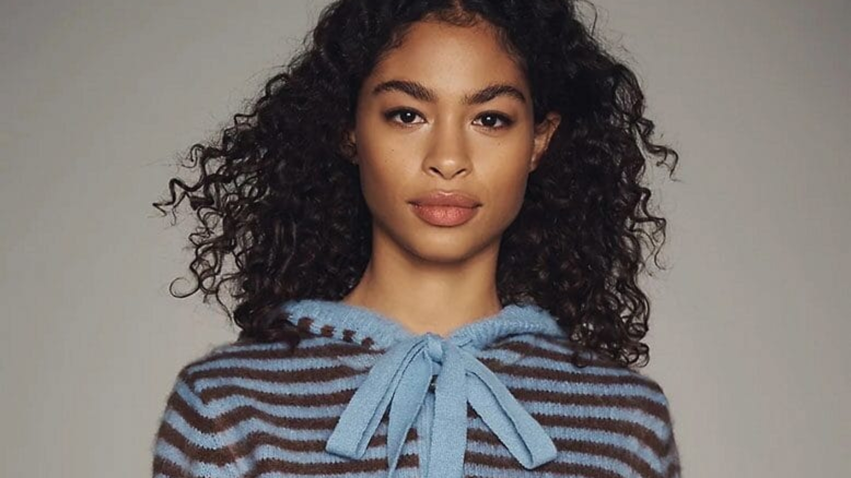Woman wearing blue-and-brown-striped cardigan