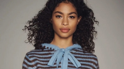 Woman wearing blue-and-brown-striped cardigan