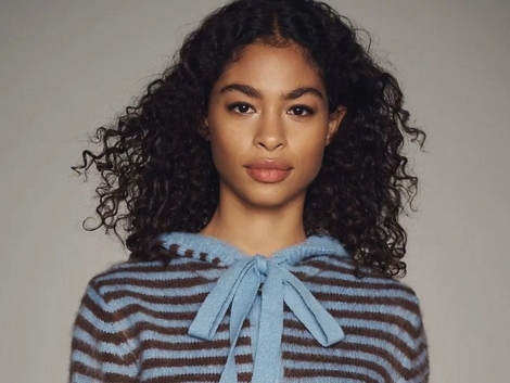 Woman wearing blue-and-brown-striped cardigan