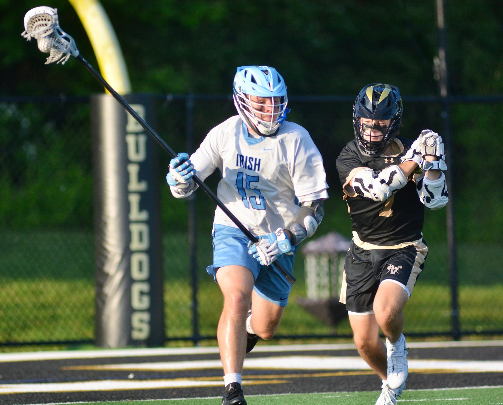 Notre Dame’s Darin Urstadt, left, runs the ball clear as...
