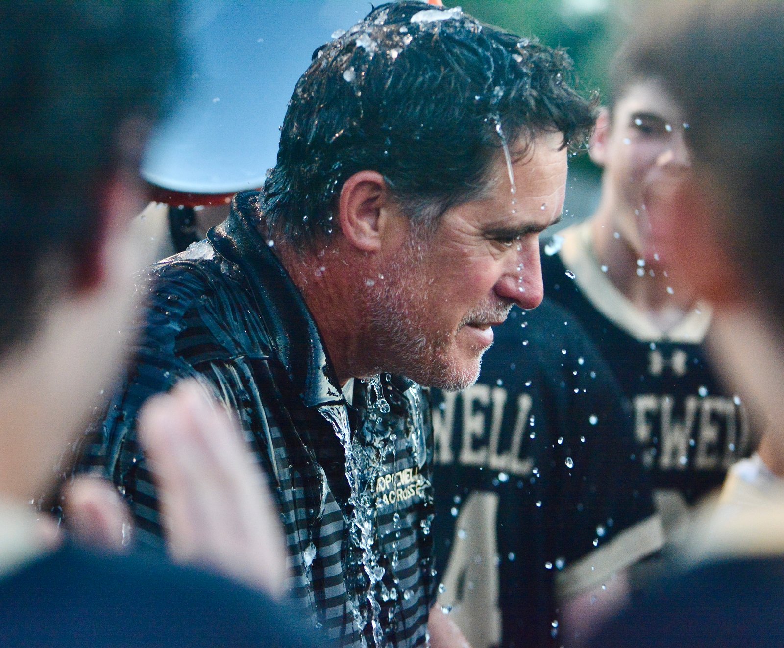 Hopewell Valley coach Matthew Foret is doused with water after...