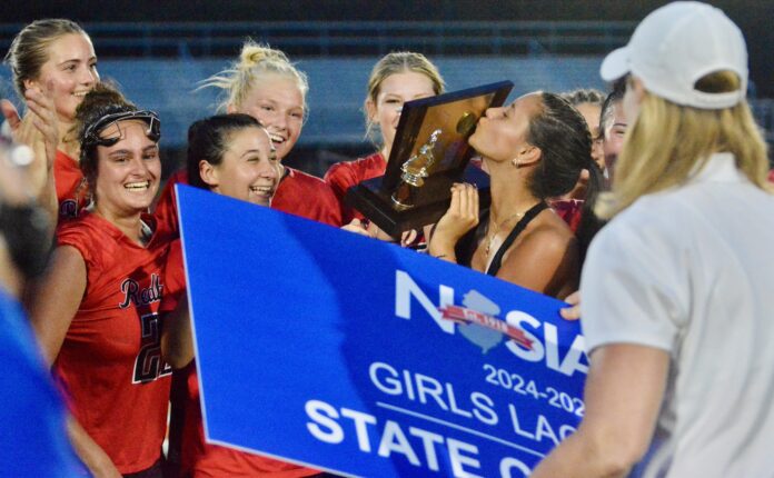 Injured Allentown senior Charley Wojtowicz kisses the championship trophy after...