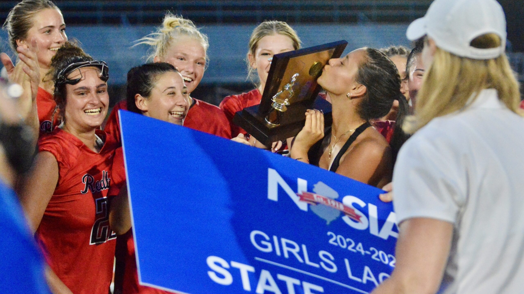 Injured Allentown senior Charley Wojtowicz kisses the championship trophy after...