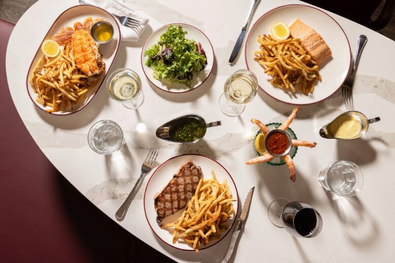 Plates of French food and drinks at Chez Frites in Atlantic City