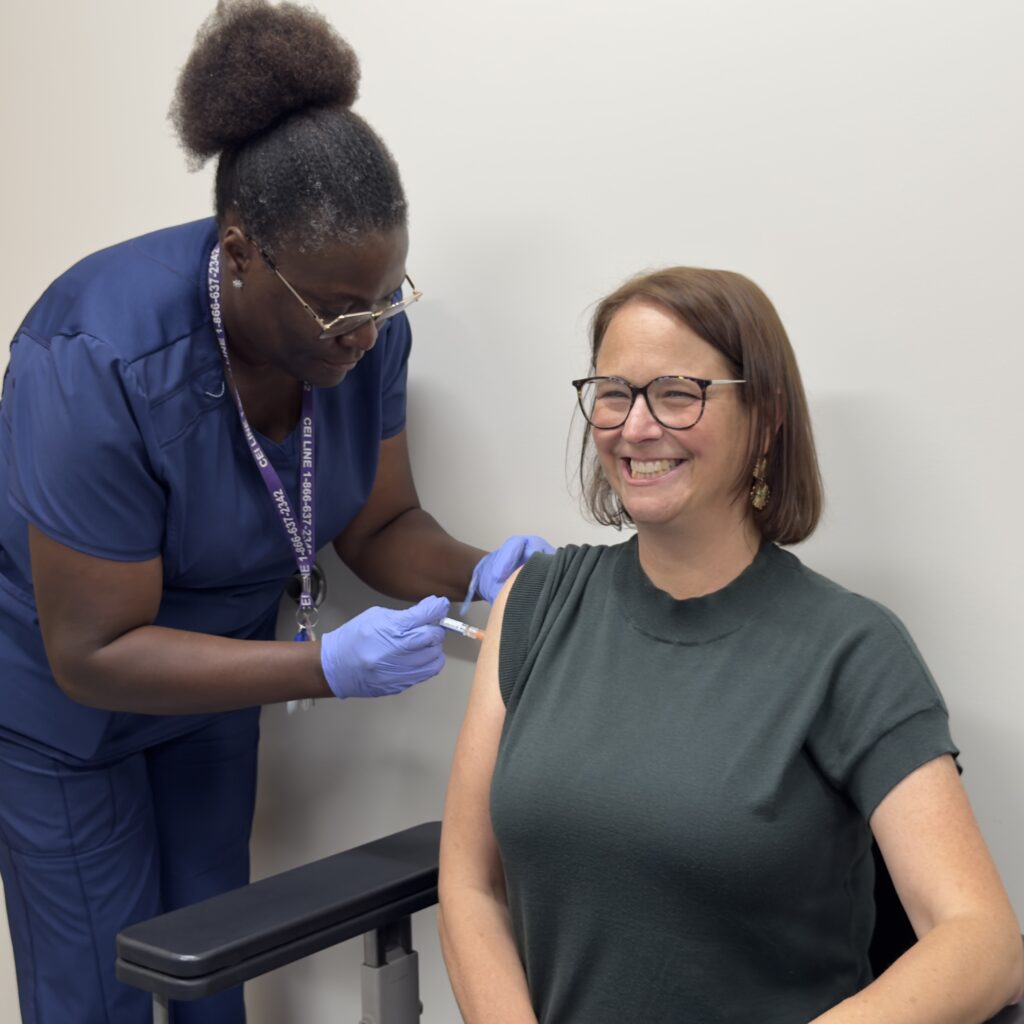 State Assemblywoman Andrea Katz receives a flu shot during a...