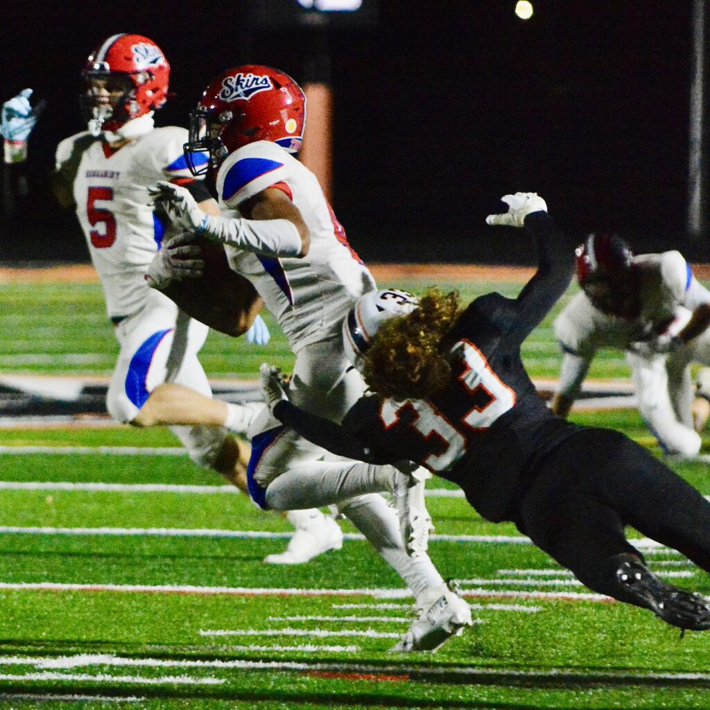 Neshaminy wide receiver Brock Williams, left, tries to get away...