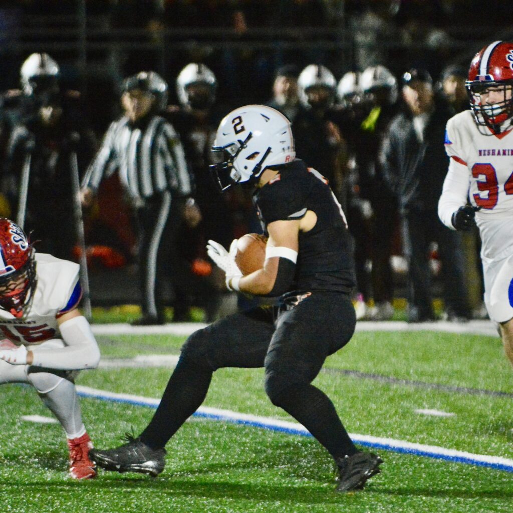 Pennsbury running back Kaiden Brown, center, looks to avoid the...