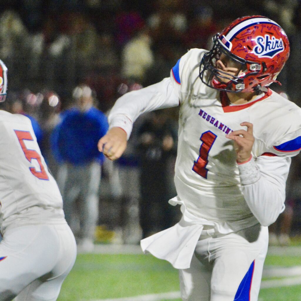 Neshaminy quarterback Michael Eckart, 1, follows through on a pass...