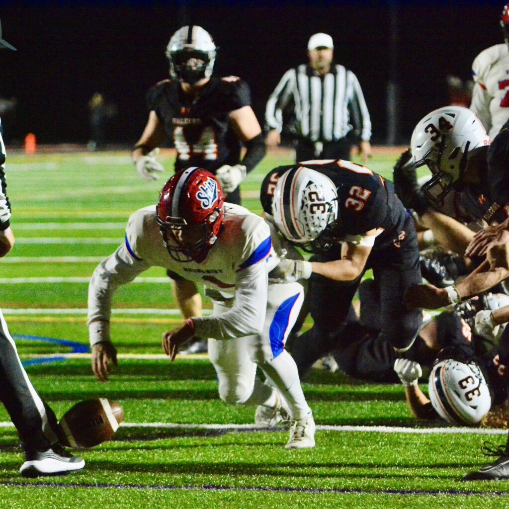 Neshaminy quarterback Michael Eckart, 1, fumbles the ball as he’s...