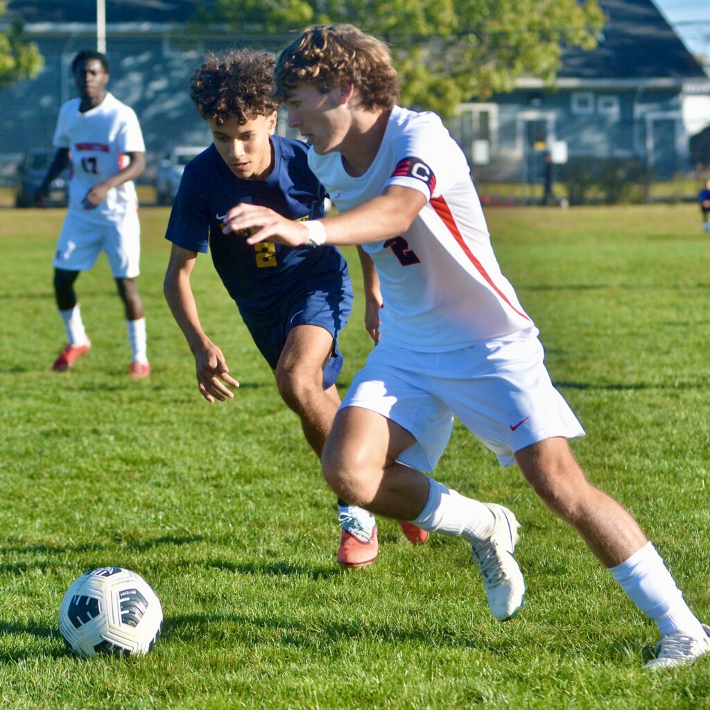 Pennington’s Kyle Harvey, right, tries to move the ball past...