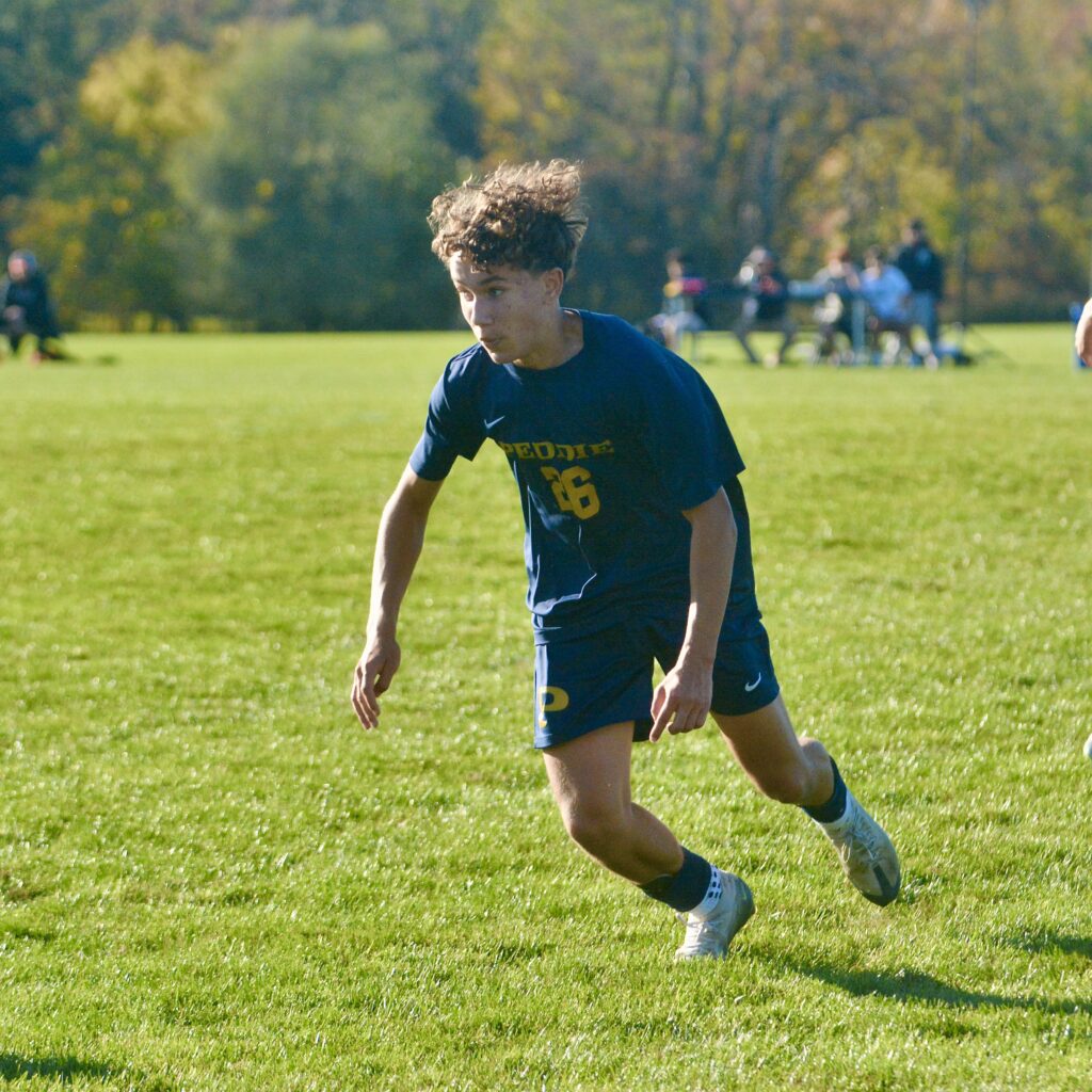 Peddie’s Blake Romanelli, left, moves toward the ball as Pennington’s...