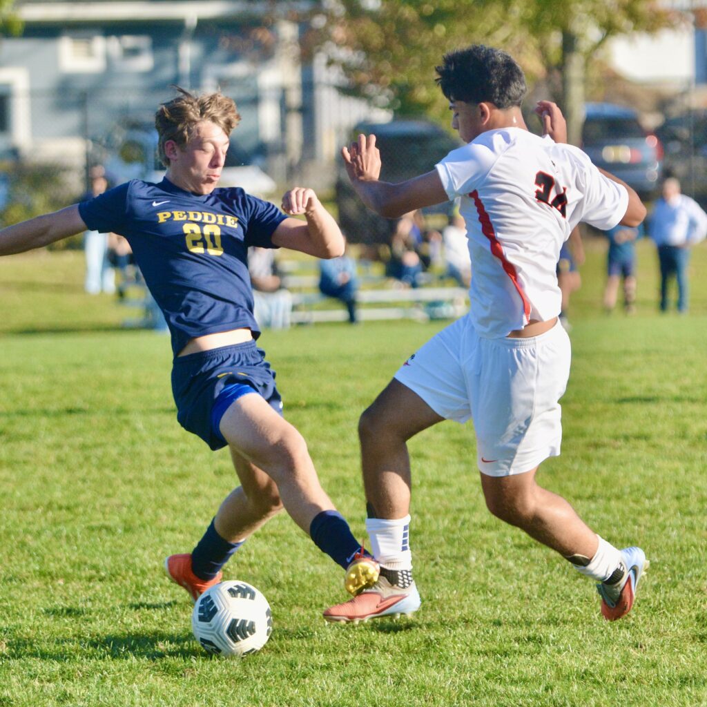 Peddie’s Brandon Schrob, left, tries to tackle the ball away...