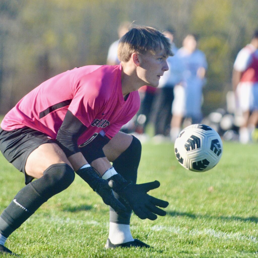 Pennington goalkeeper Colin Harkelroad saves the ball against Peddie during...