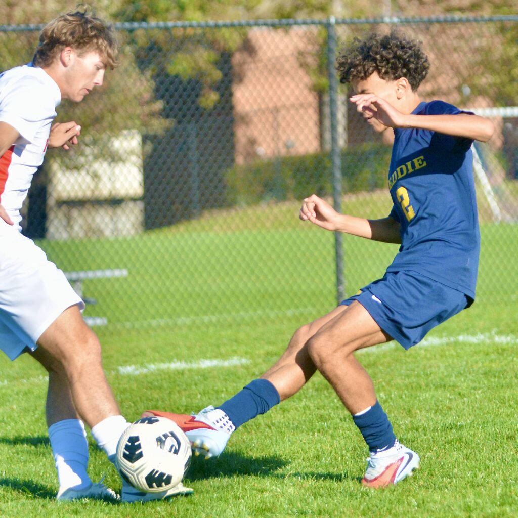 Pennington’s Kyle Harvey, left, and Peddie’s Luca Romanelli, right, challenge...