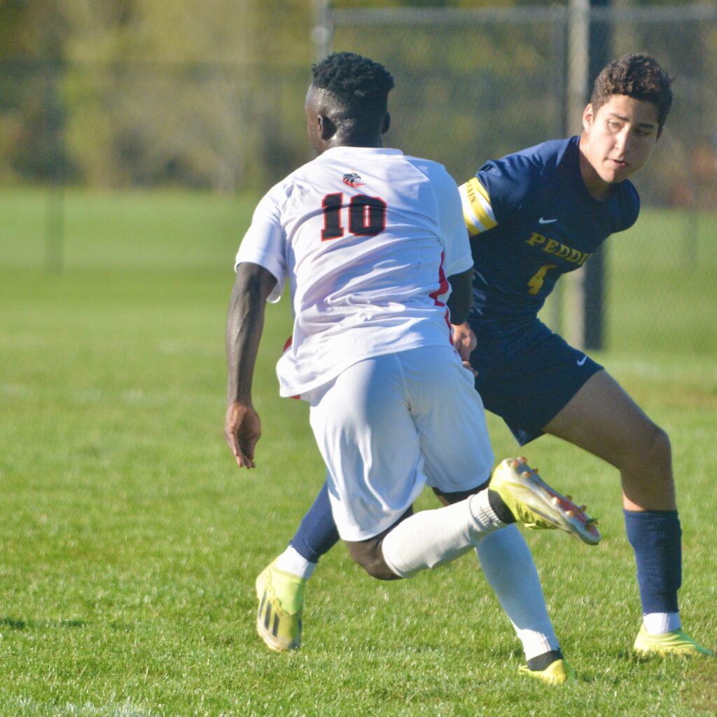 Pennington’s Matthew Addai, 10, tries to move pat Peddie’s Juan...