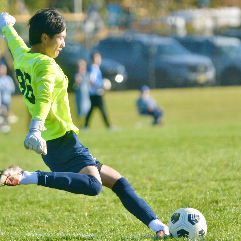 Peddie goalkeeper Pote Sophonsiri kicks the ball up the field...
