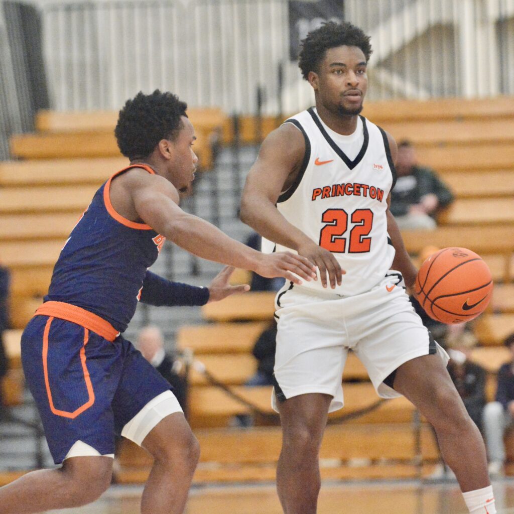 Princeton’s Dalen Davis, right, dribbles the ball up the court...