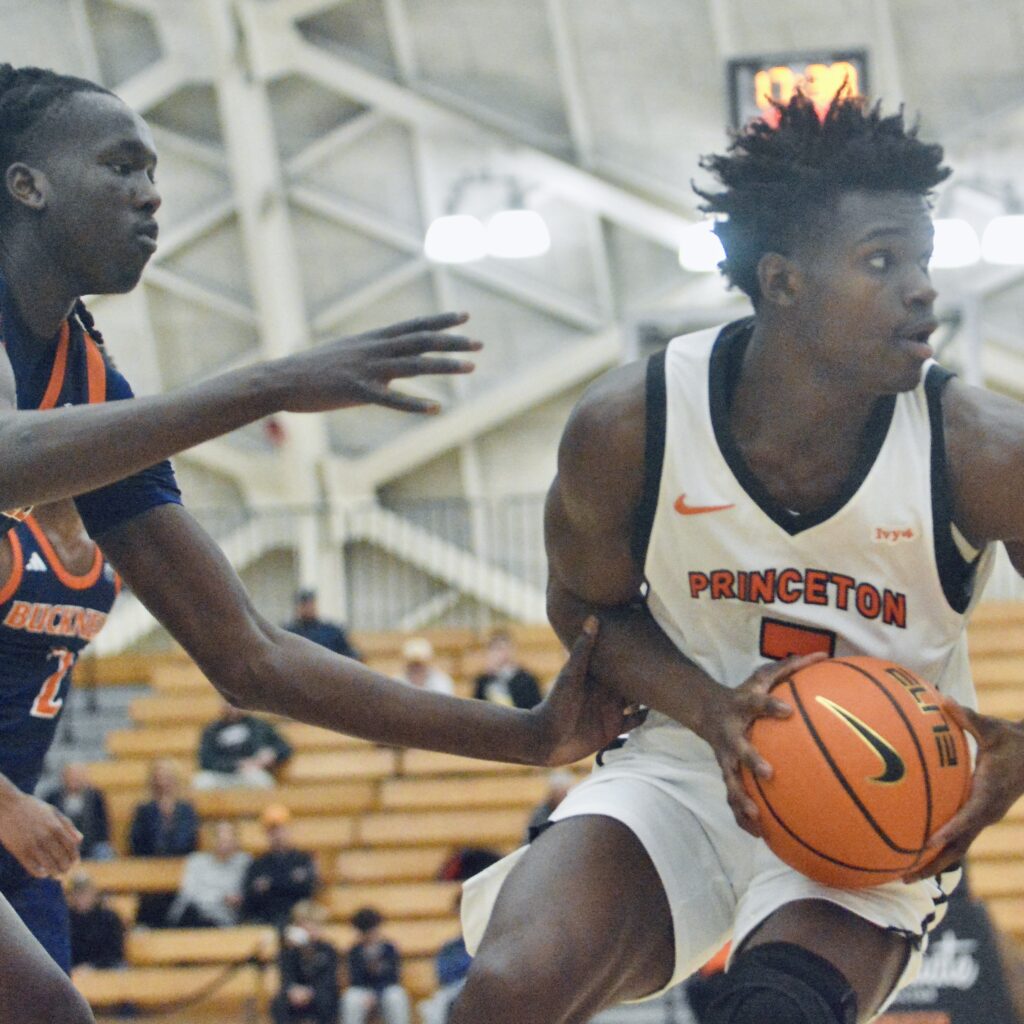 Princeton’s Malik Abdullahi, right, controls the ball as Bucknell’s Ruot...