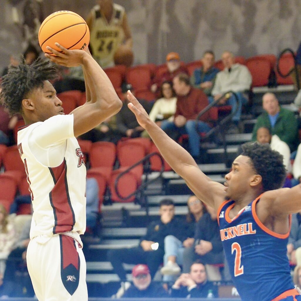 Rider’s Flash Burton, left, shoots over the defense of Bucknell’s...